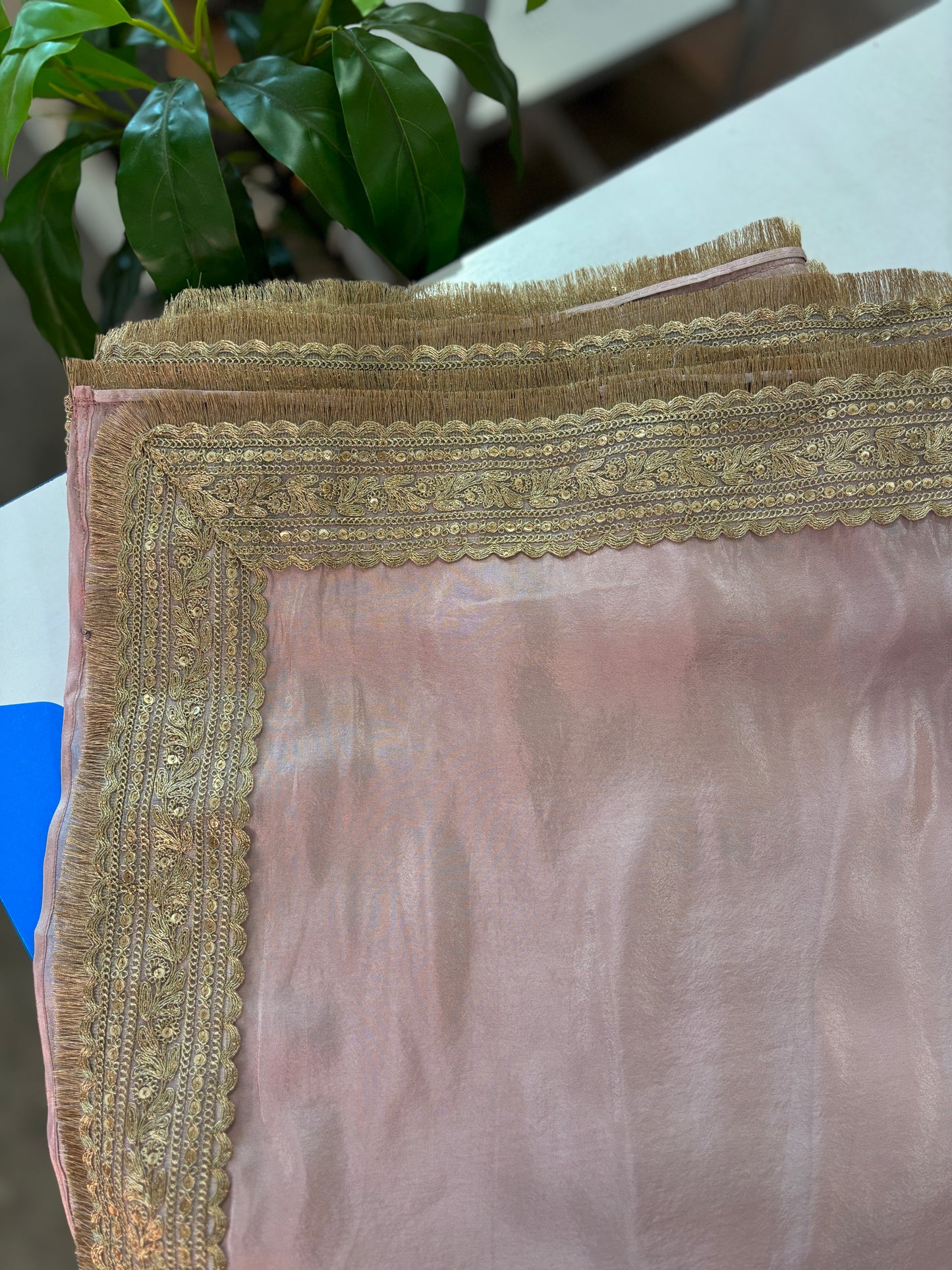 Baby pink tissue pre-draped saree with golden borders